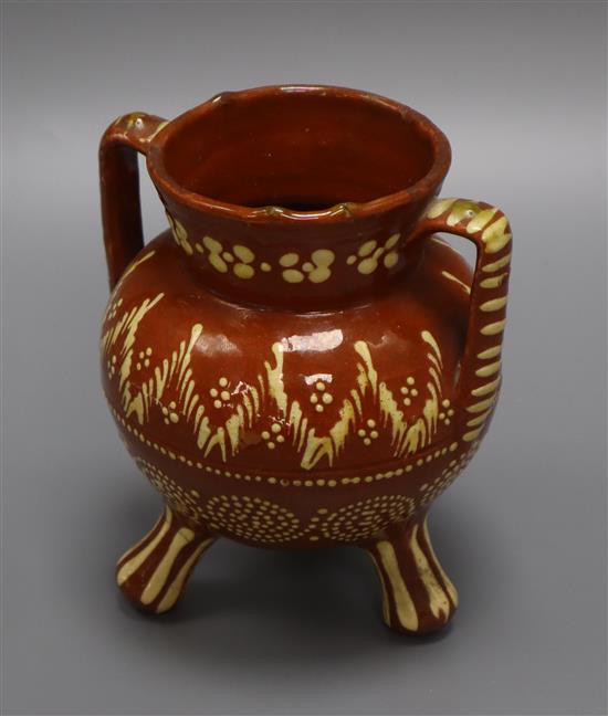 A 19th century Sussex slipware pottery tripod vase height 15cm